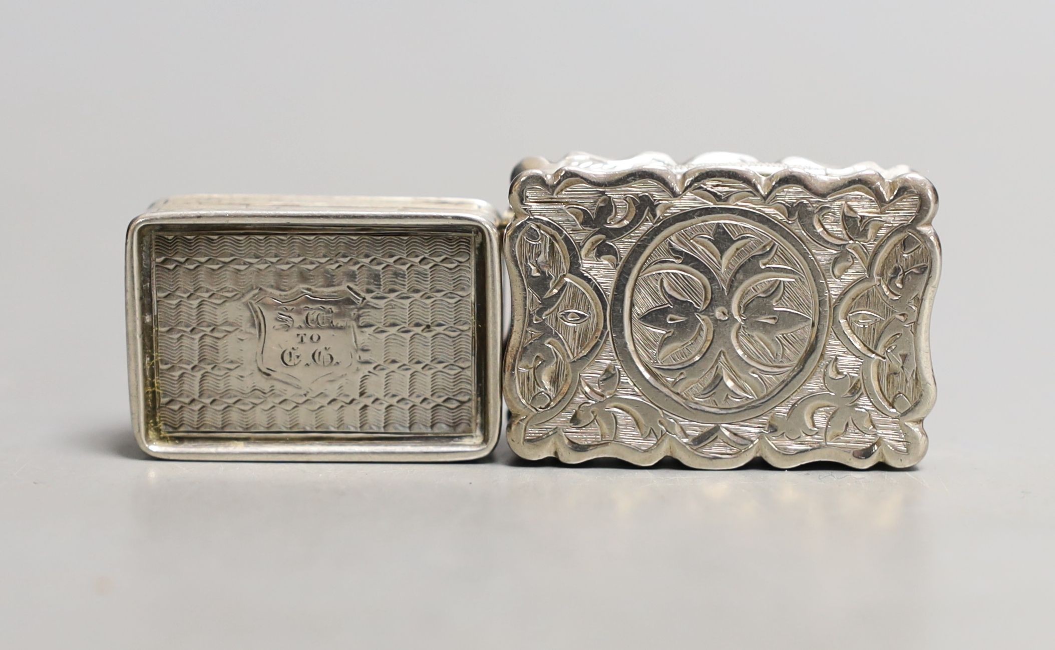 A Victorian engraved silver vinaigrette, D & M, Birmingham, 1876, 35mm and a smaller earlier vinaigrette by Francis Clark.